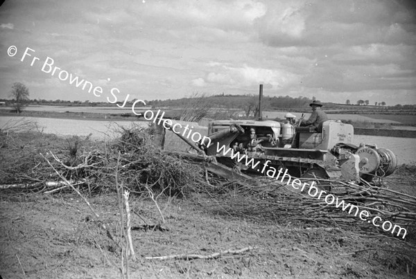 BULLDOZER  CLEARING SCRUB AND TREES  NEAR LAKE